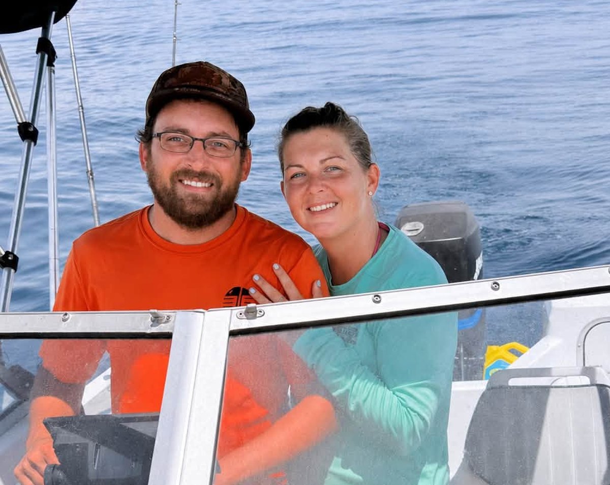 Matt and Lindsey Parham at the helm of their boat offshore